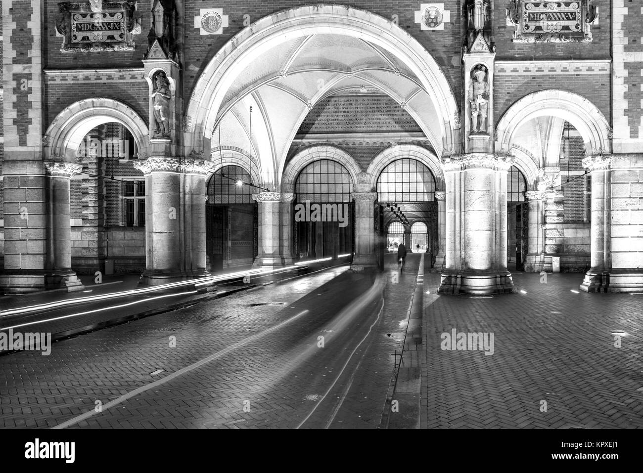 Cyclistes roulent à travers Rijksmuseum arch dans la nuit. Amsterdam, Pays-Bas, Europe Banque D'Images