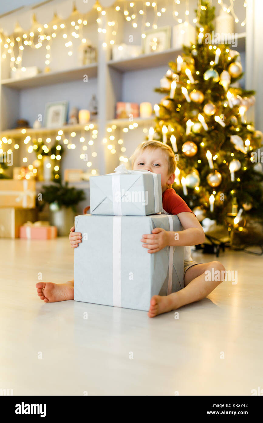 Le jour de l'an photo de garçon avec boîte-cadeau sur fond de décorations de Noël Banque D'Images