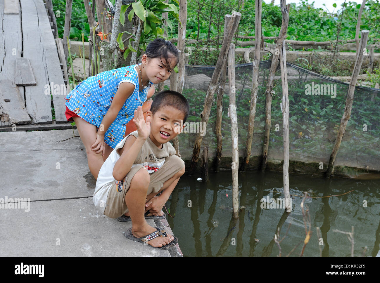 Les enfants vietnamiens dans le delta du Mékong à Ben Tre. Le Mékong est une voie majeure pour le transport en Asie du sud-est. Banque D'Images