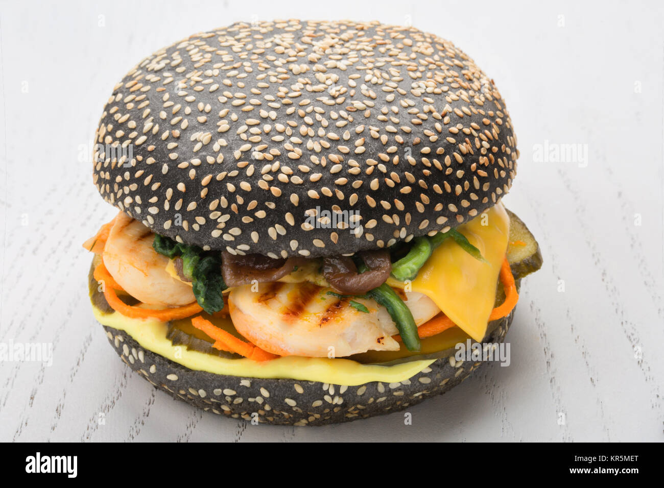 Burger de poulet noir avec grill, le cornichon, épinards fromage. bun