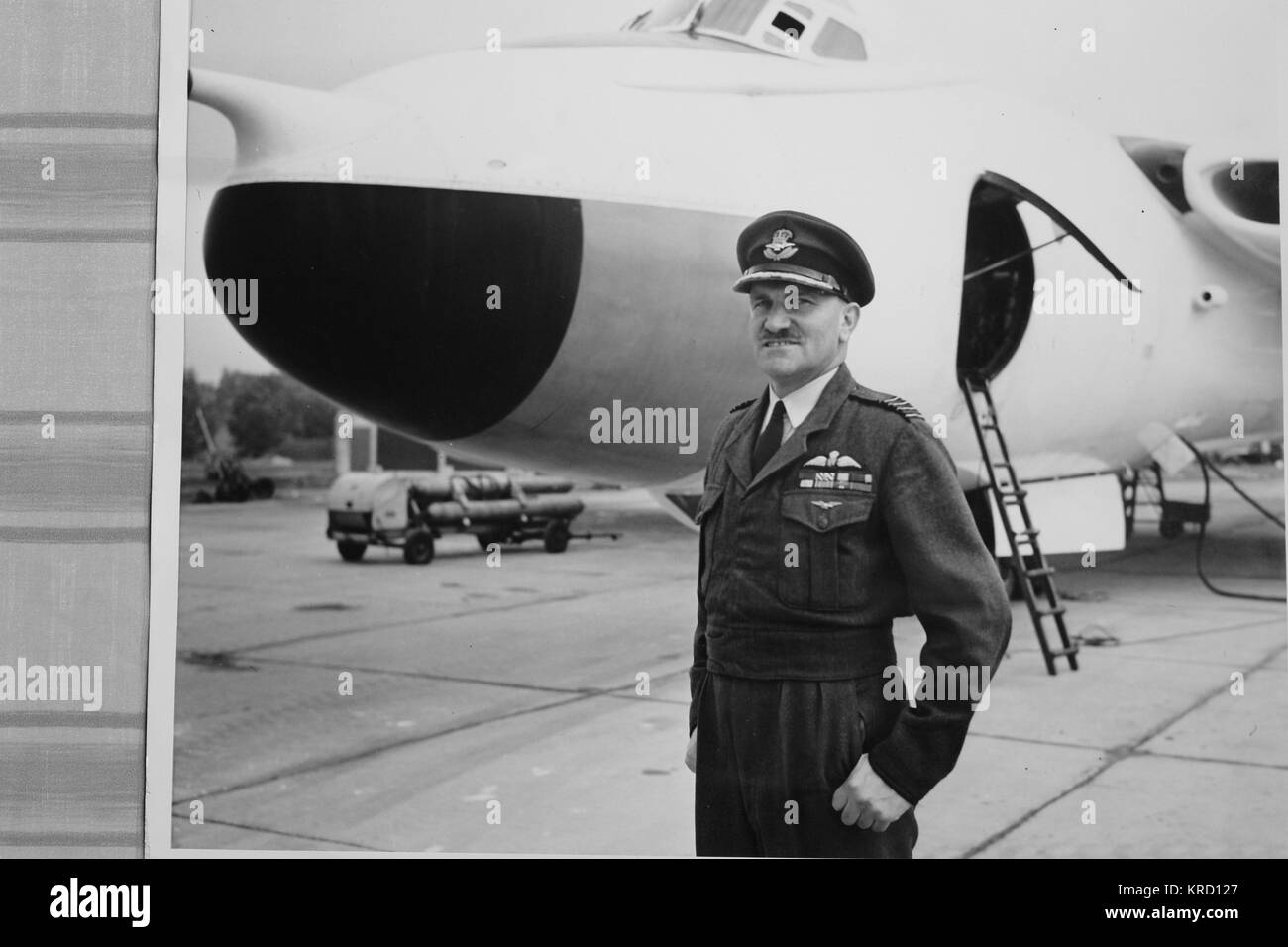 Le Capitaine John Groupe (Woodroffe c1914-1957), commandant de la station RAF Wittering. Il meurt dans un American B47 Stratojet survenu en octobre 1957 au cours d'une compétition de vol à Pinecastle AFB, en Floride, aux États-Unis. Vu ici en uniforme, debout sur un aérodrome avec un avion à l'arrière-plan. Banque D'Images