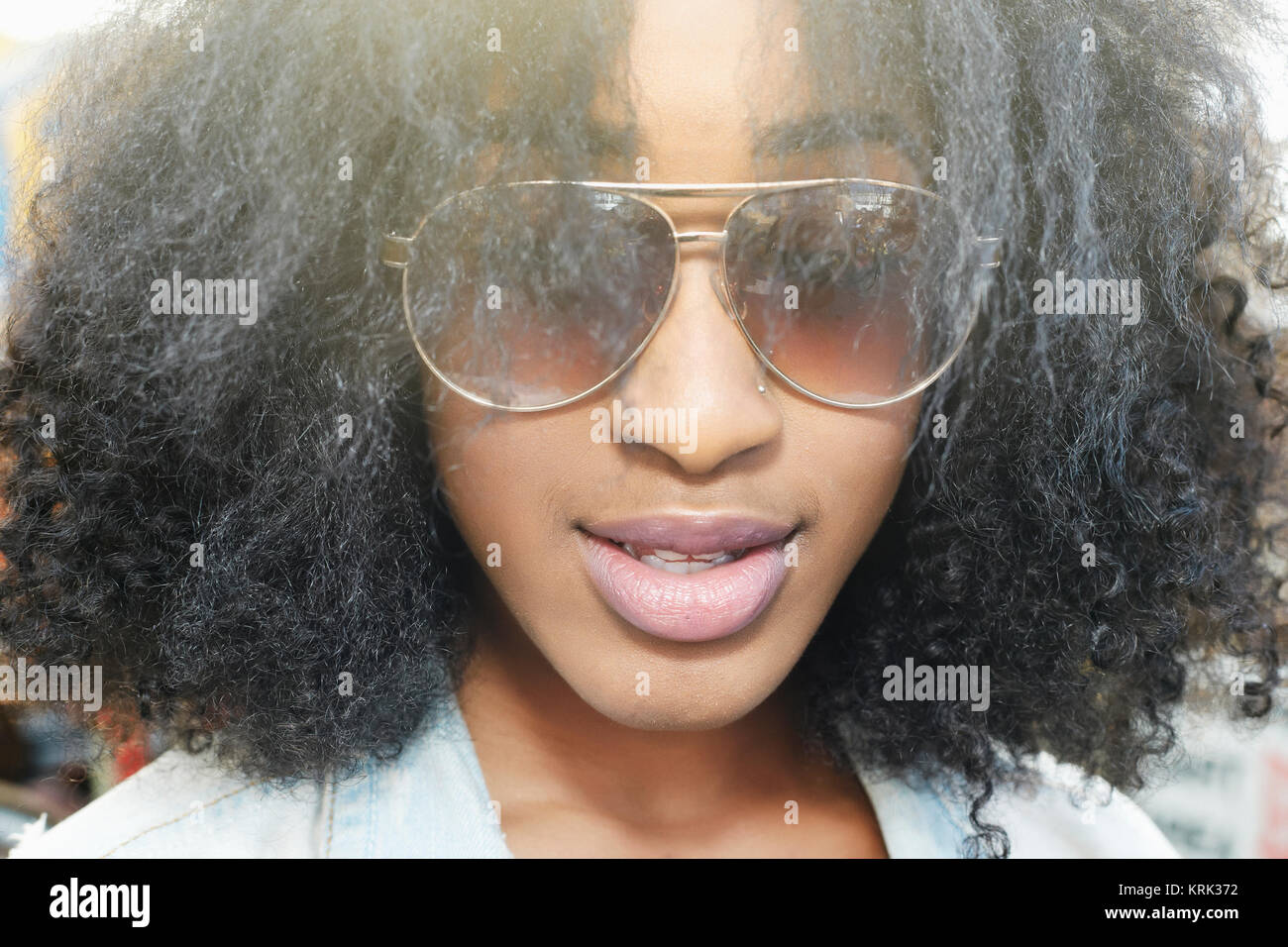 Close up of mixed race woman wearing sunglasses Banque D'Images