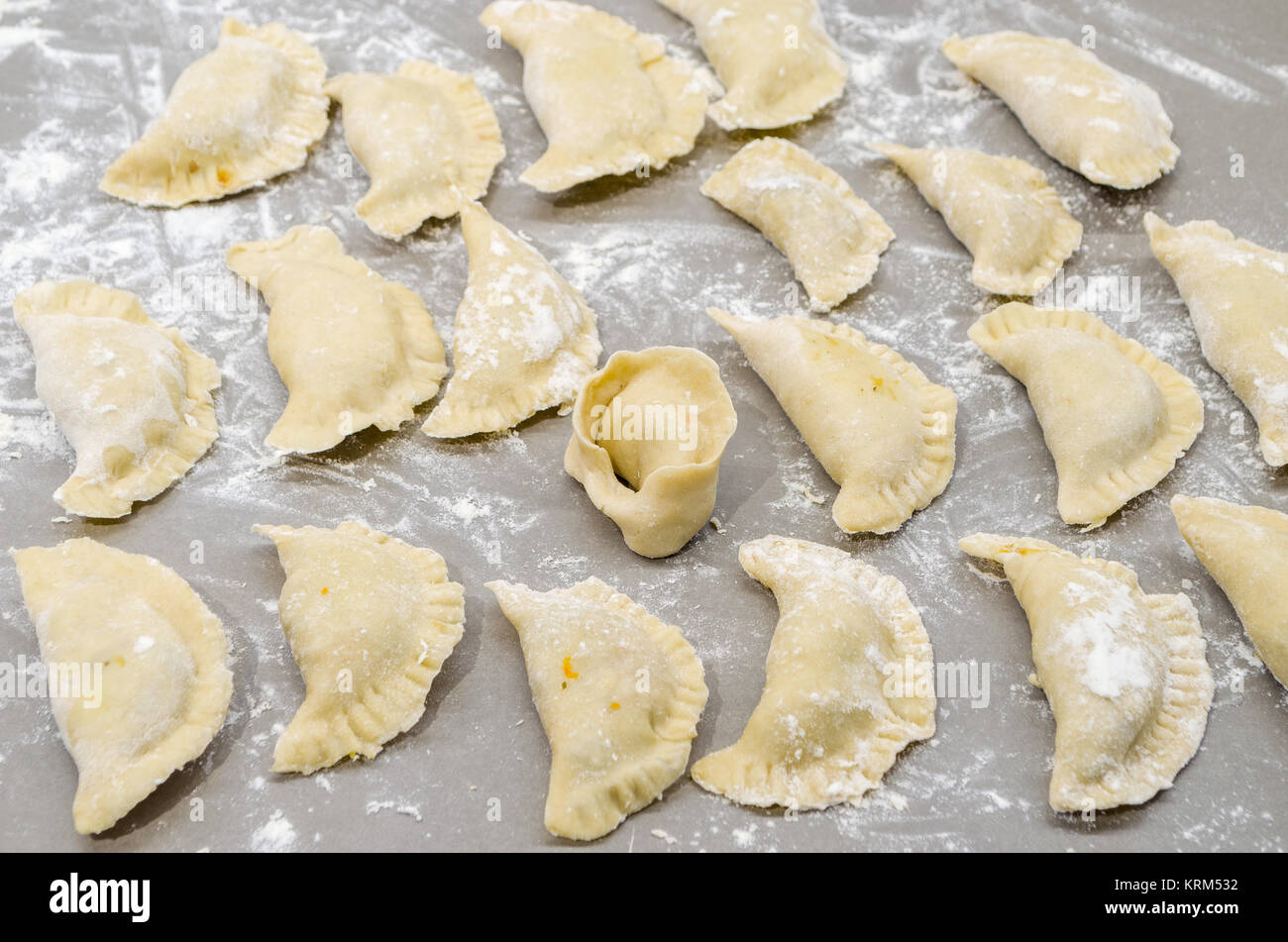 Non-authentique traditionnelle ont organisé la veille de Noël polonais pierogies sur table dans une cuisine moderne avec un ushko, pendant la préparation- prêt à bouillir. Banque D'Images