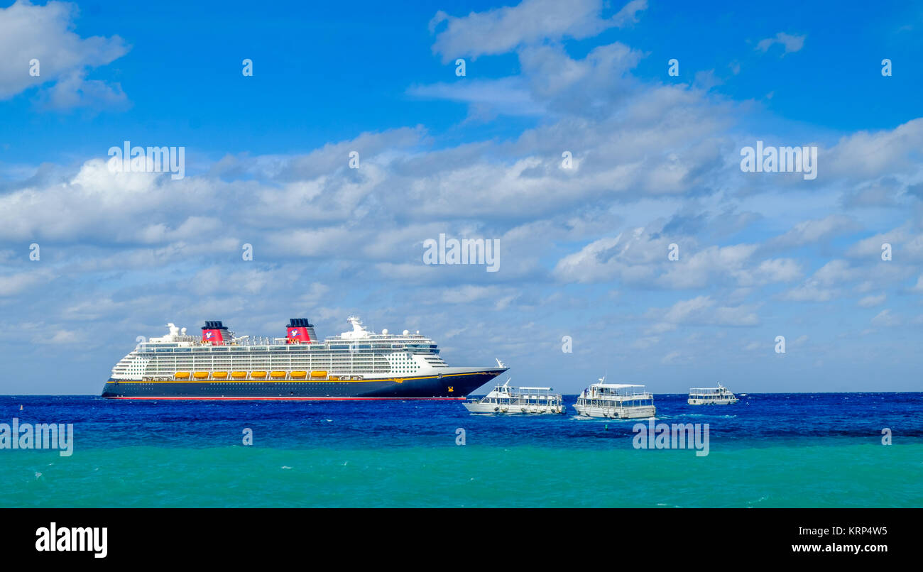 Grand Cayman, îles Caïmans, Dec 2017, bateau de croisière Disney Fantasy avec des navettes maritimes sur la mer des Caraïbes près de Port George Town Banque D'Images