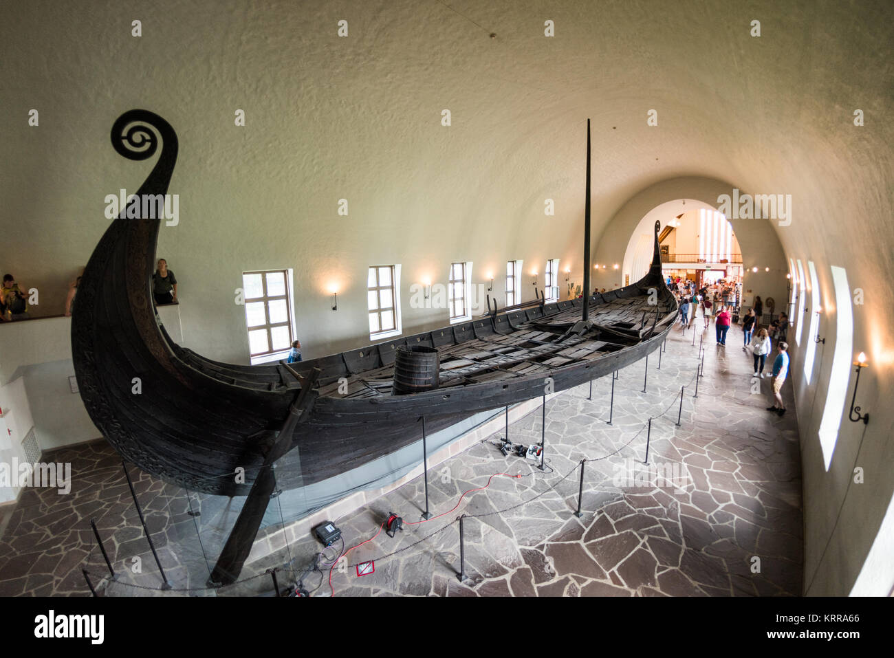 OSLO, Norvège - l'Oseberg ship est un bateau viking bien conservé qui est l'un des points forts à la Viking Ship Museum à Oslo. Il est nommé d'après la ferme où elle a été trouvée en 1903. Il est soupçonné d'avoir été construit dans l'ouest de la Norvège autour de 820AD et a été régulièrement utilisé pour un certain nombre d'années avant d'être utilisé comme un navire tombe pour deux femmes en 834 AD. Leurs corps ont été placés dans le centre du navire, avec un riche assortiment d'hommages. Il est construit de chêne et mesure 22 mètres de long et 5 mètres de large. Il pourrait être ramé ou navigué. L'Oslo Viking Ship Museu Banque D'Images