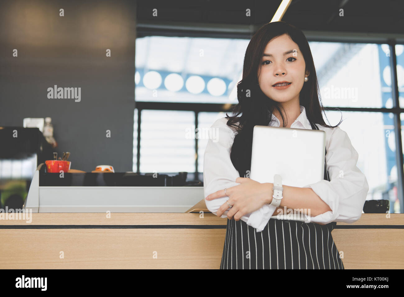 Propriétaire de petite entreprise holding tablet in coffee shop. asian female barista de porter un tablier à l'aide au touchpad dans bar cafe. service alimentaire, restaur Banque D'Images