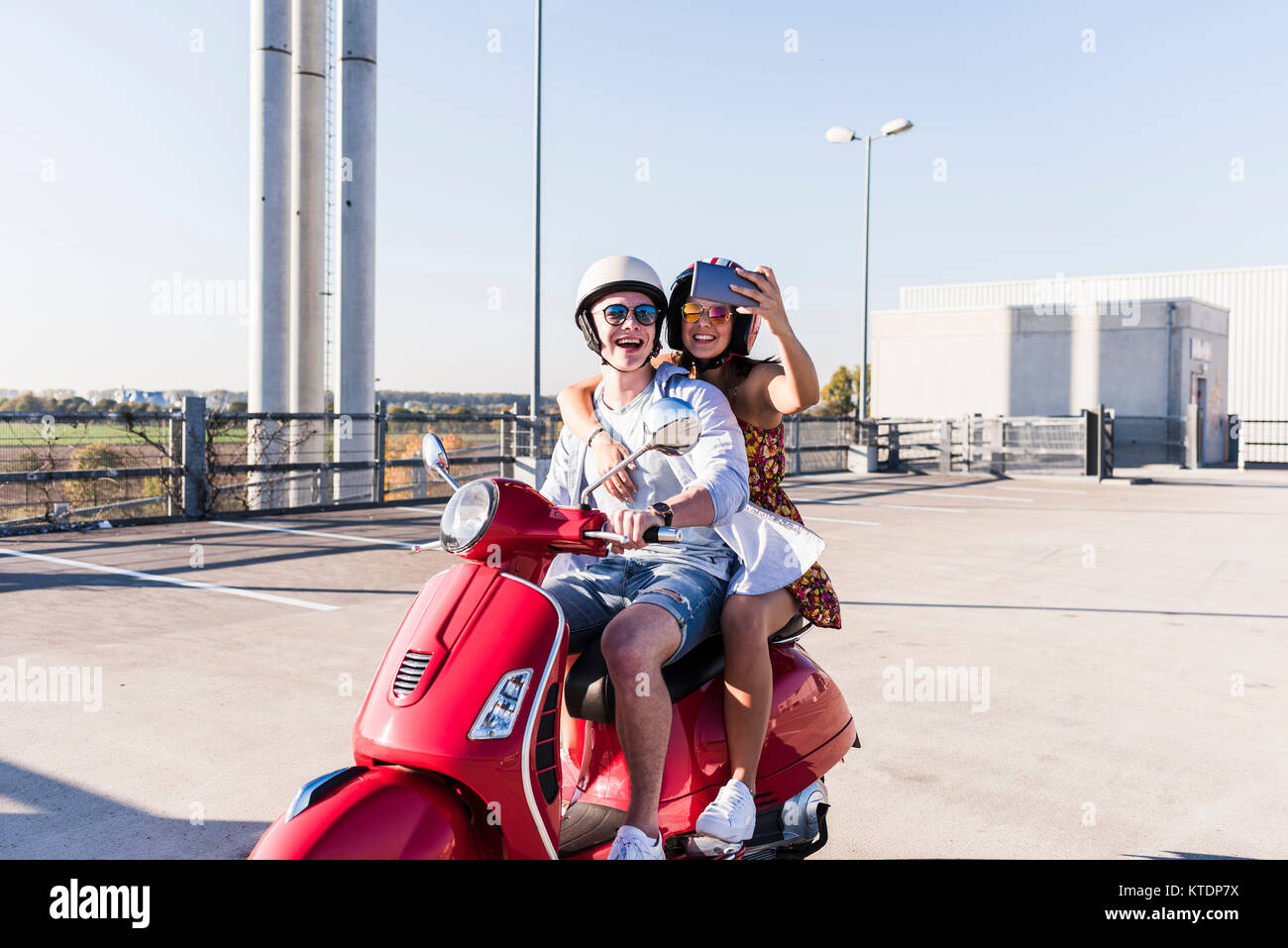 Couple de prendre un scooter sur selfies sur niveau parking Banque D'Images