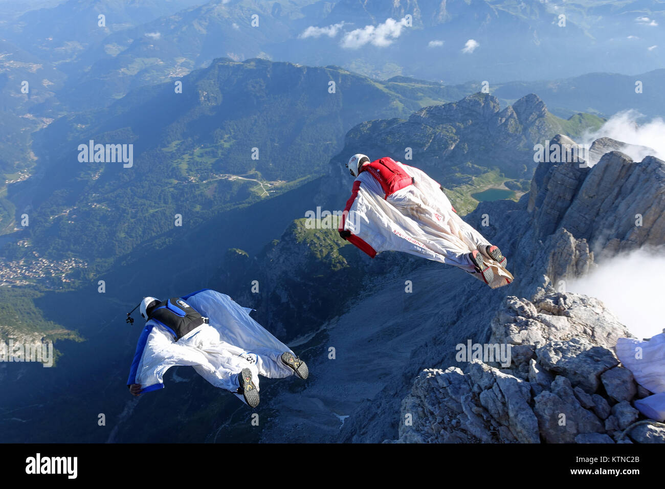 Deux pilotes wingsuit sortent parallèlement d'une falaise et de l'expérience un ensemble de proximité. Ils ne savent pas ce qui est à venir en chute libre. Banque D'Images