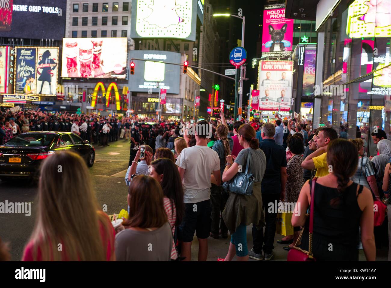 Au cours d'une vie noir Question manifestation à New York Times Square à la suite des coups de décès de Alton Sterling et Philando Castille, militants de bloquer le trafic et affrontez une ligne de policiers de New York (NYPD) La police anti-émeute comme touristes, regardez sur New York City, New York, 7 juillet 2016. Banque D'Images