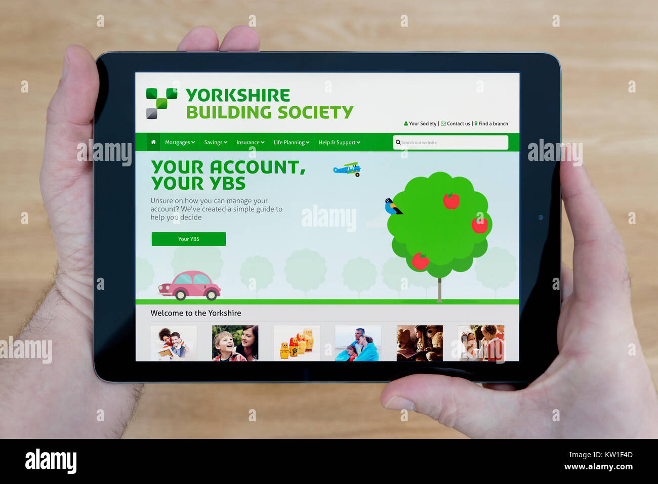 Un homme regarde les Yorkshire Building Society site sur son iPad tablet device, tourné contre une table en bois page contexte (usage éditorial uniquement) Banque D'Images