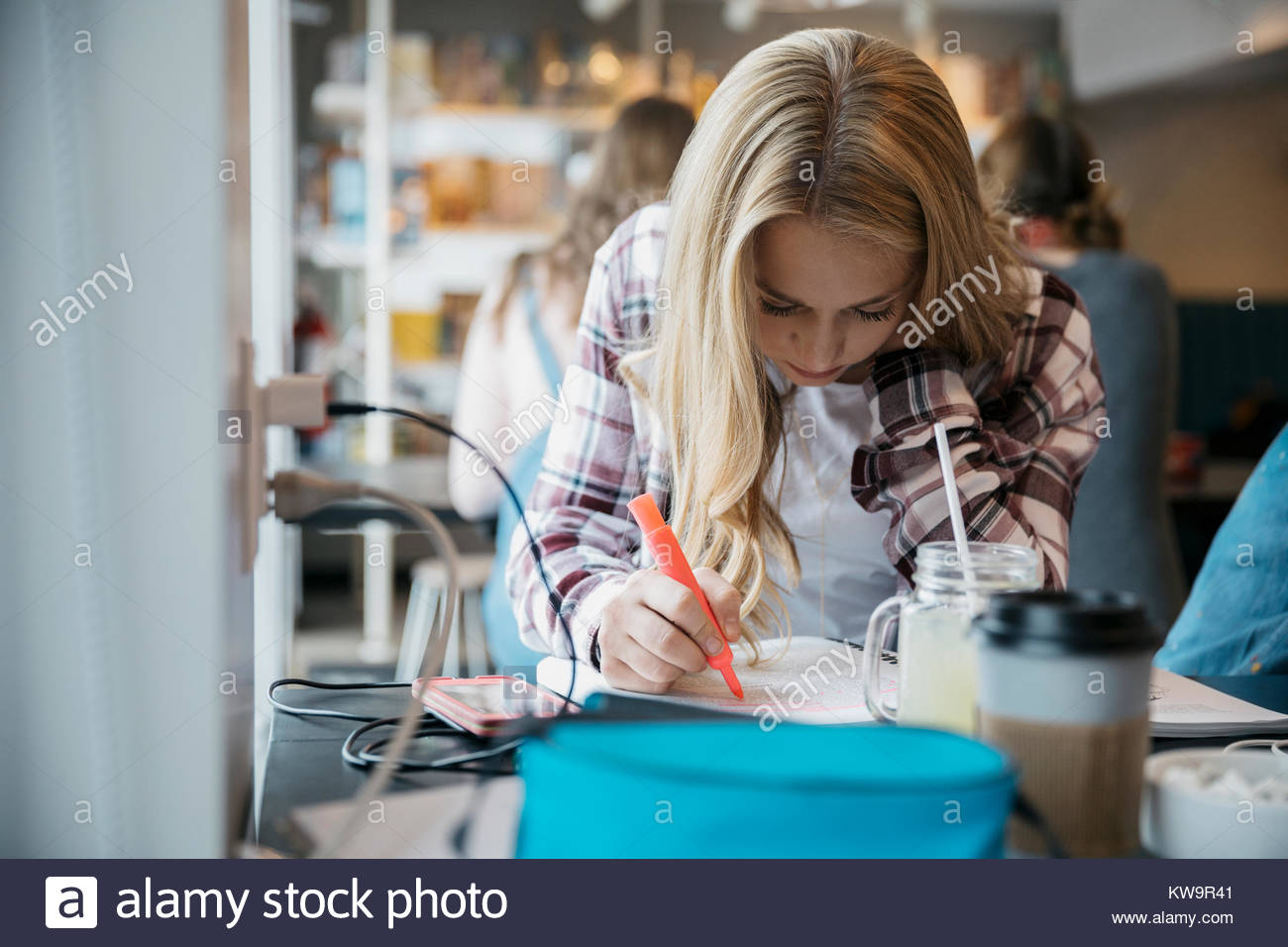 L'accent Caucasian girl high school student studying in cafe Banque D'Images