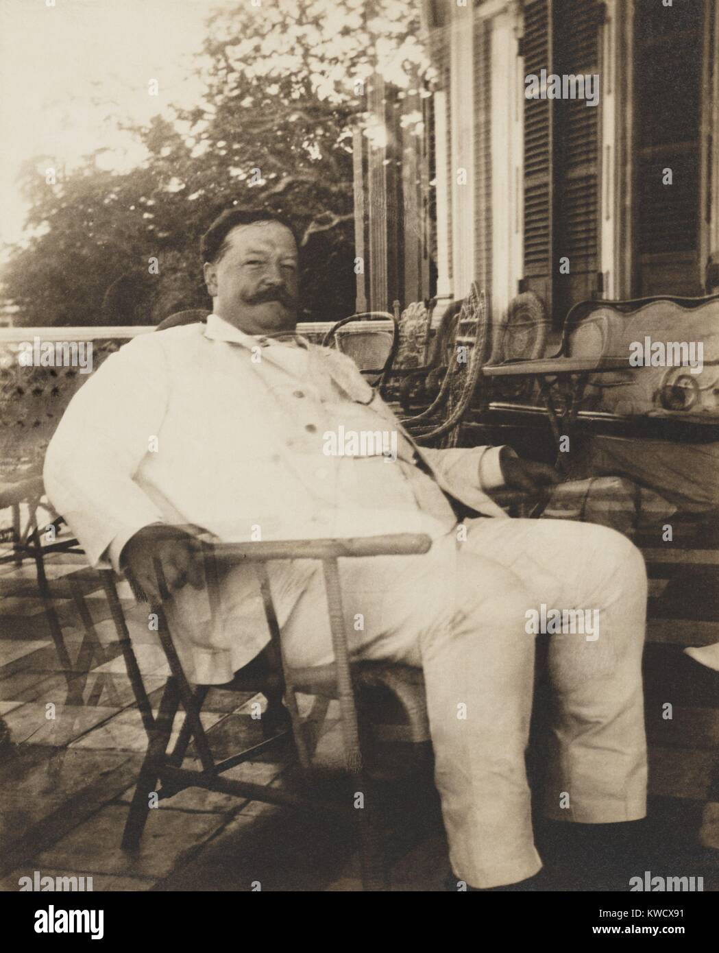 Futur Président, William H. Taft, de gouverneur général des Philippines, 1901-1903. Il est assis sur un porche, dans un fauteuil en osier, dans un costume blanc (BSLOC tropical 2017 2 94) Banque D'Images