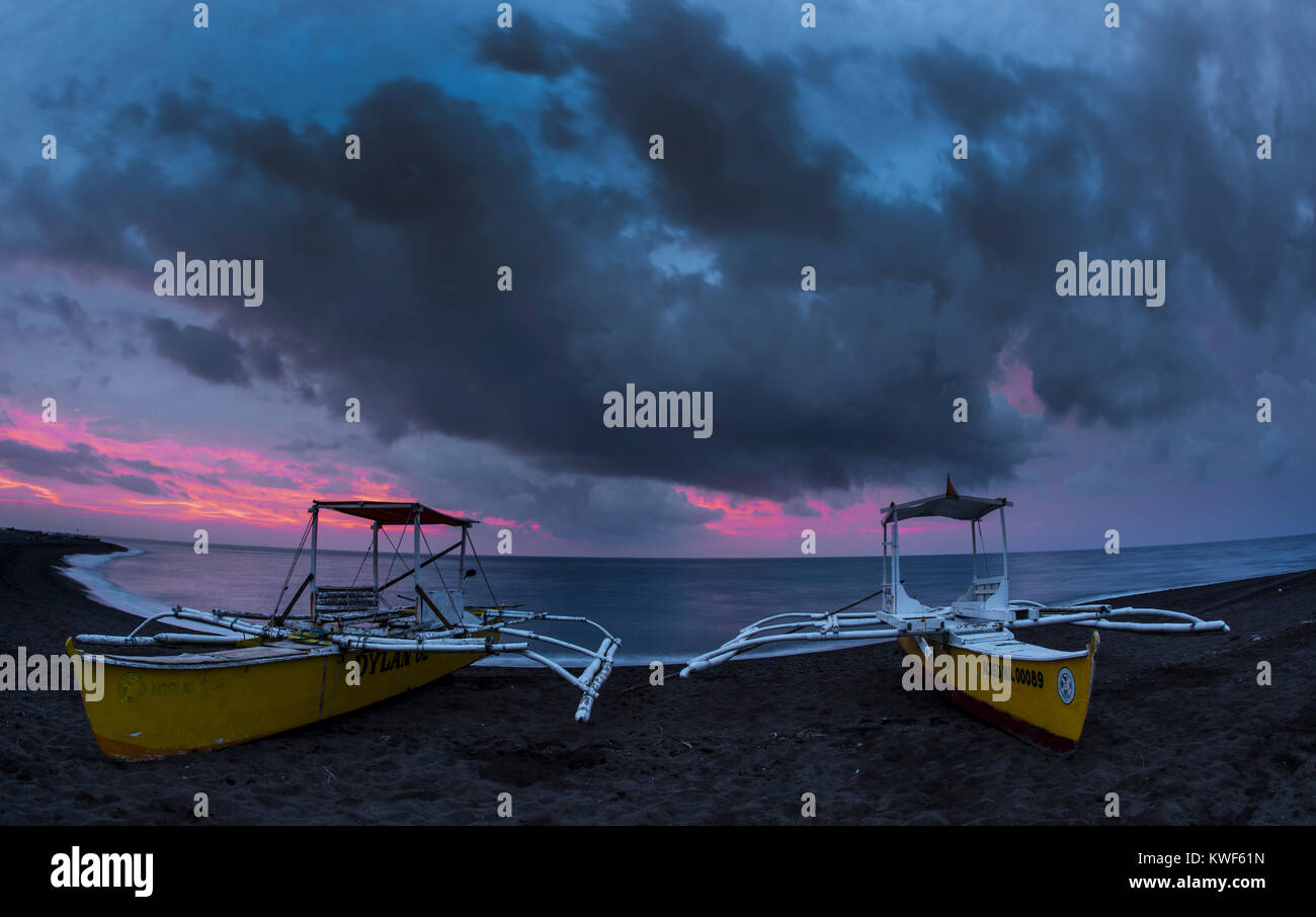 Coucher de soleil sur Camiguin avec des bateaux au premier plan Banque D'Images