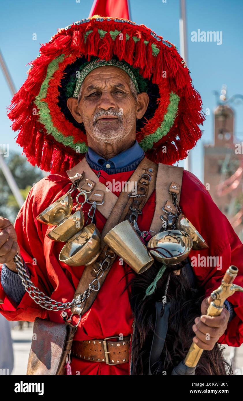 Vendeur d'eau traditionnels et la Koutoubia avec drapeau marocain. Banque D'Images