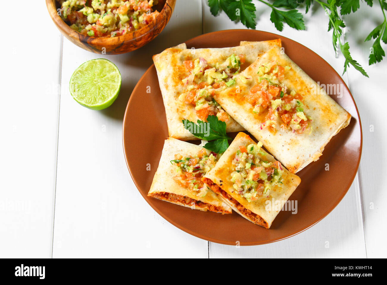 Un Plat Traditionnel Mexicain Chimichanga Gateau De Mais Avec De La Viande Hachee Le Poivre L Oignon L Ail L Origan Zira Et Sauce A L Avocat De Guacomole Photo Stock Alamy
