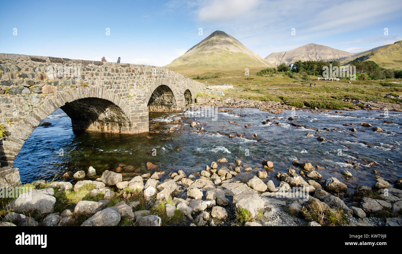 Old Stone arch bridge sur une rivière de montagne à Sligachan sur l'île de Skye dans les Highlands d'Écosse, avec les montagnes de l'augmentation des Cuillin Banque D'Images