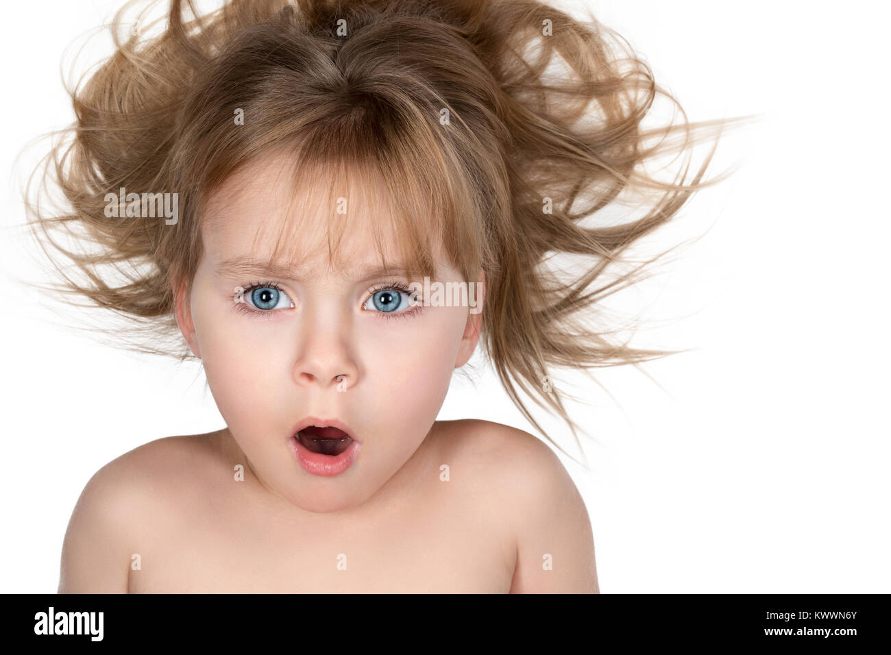 Portrait d'un enfant surpris avec la bouche ouverte et les cheveux ébouriffés isolé sur fond blanc Banque D'Images