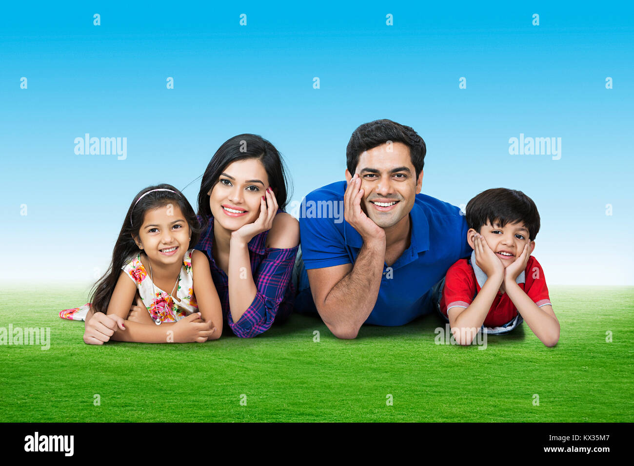Heureux en famille Les parents et les enfants ensemble dans l'Herbe couchée Park Banque D'Images