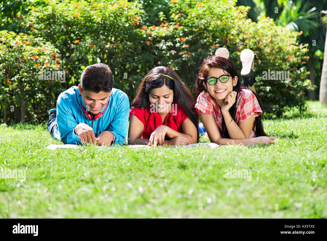 3 Indian College adolescents amis parler des potins de la communication du parc à pied Banque D'Images