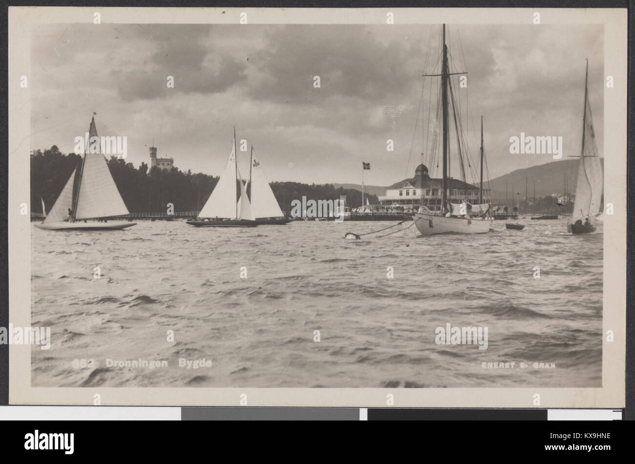 Cette photographie intitulée « Dronningen Bygd » représente un village norvégien traditionnel, présentant une architecture rurale typique et offrant un regard historique sur la vie du village norvégien. Il reflète le patrimoine culturel du pays. Banque D'Images