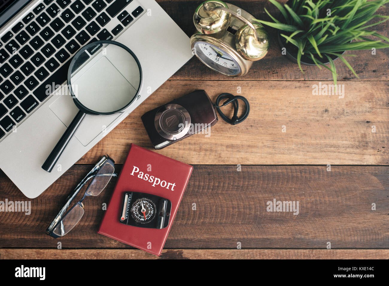 Ordinateur portable, portable, smartphone, boussole, passeport, horloge et appareil photo sur fond de table en bois. travel concept Banque D'Images