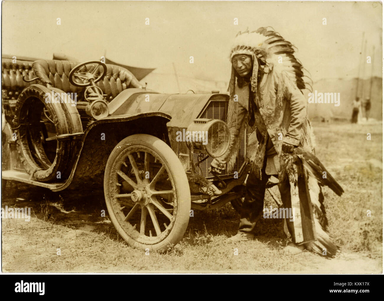 Native American Indian avec Full Regalia et coiffure. De Cheval à l'automobile - vers 1915. Banque D'Images