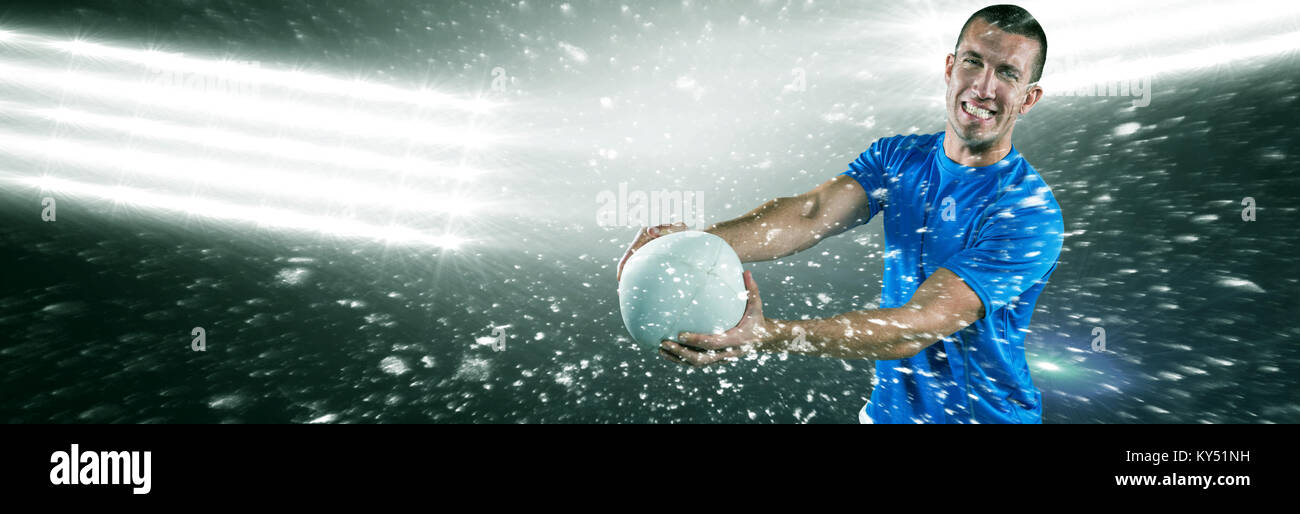 Image composite de portrait of smiling rugby player en jersey bleu holding ball Banque D'Images