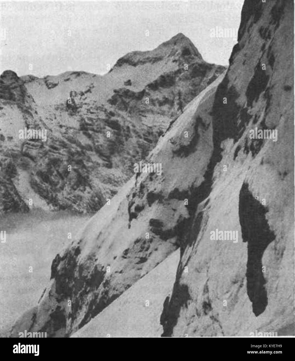 Photographie du mont Triglav depuis le mur sud-est du Rokava, montrant un terrain alpin accidenté, des pics rocheux et des pentes enneigées, illustrant la géographie naturelle de la montagne. Banque D'Images