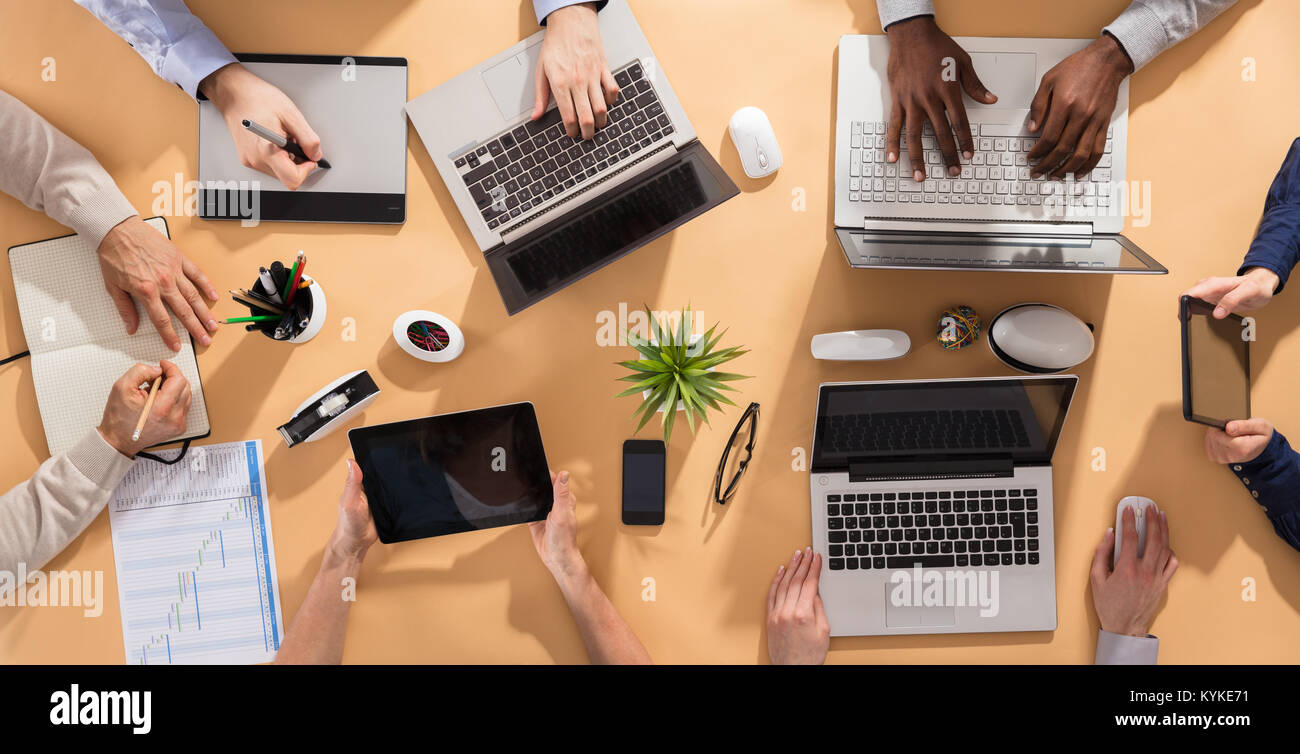 Vue de dessus de la main d'affaires travaillant sur Office bureau avec ordinateur portable et tablette numérique Banque D'Images