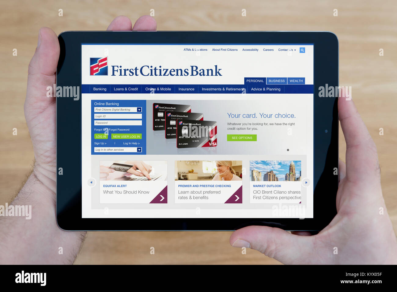 Un homme regarde les premiers citoyens Site internet de la Banque mondiale sur son iPad tablet device, avec une table en bois page contexte (usage éditorial uniquement) Banque D'Images