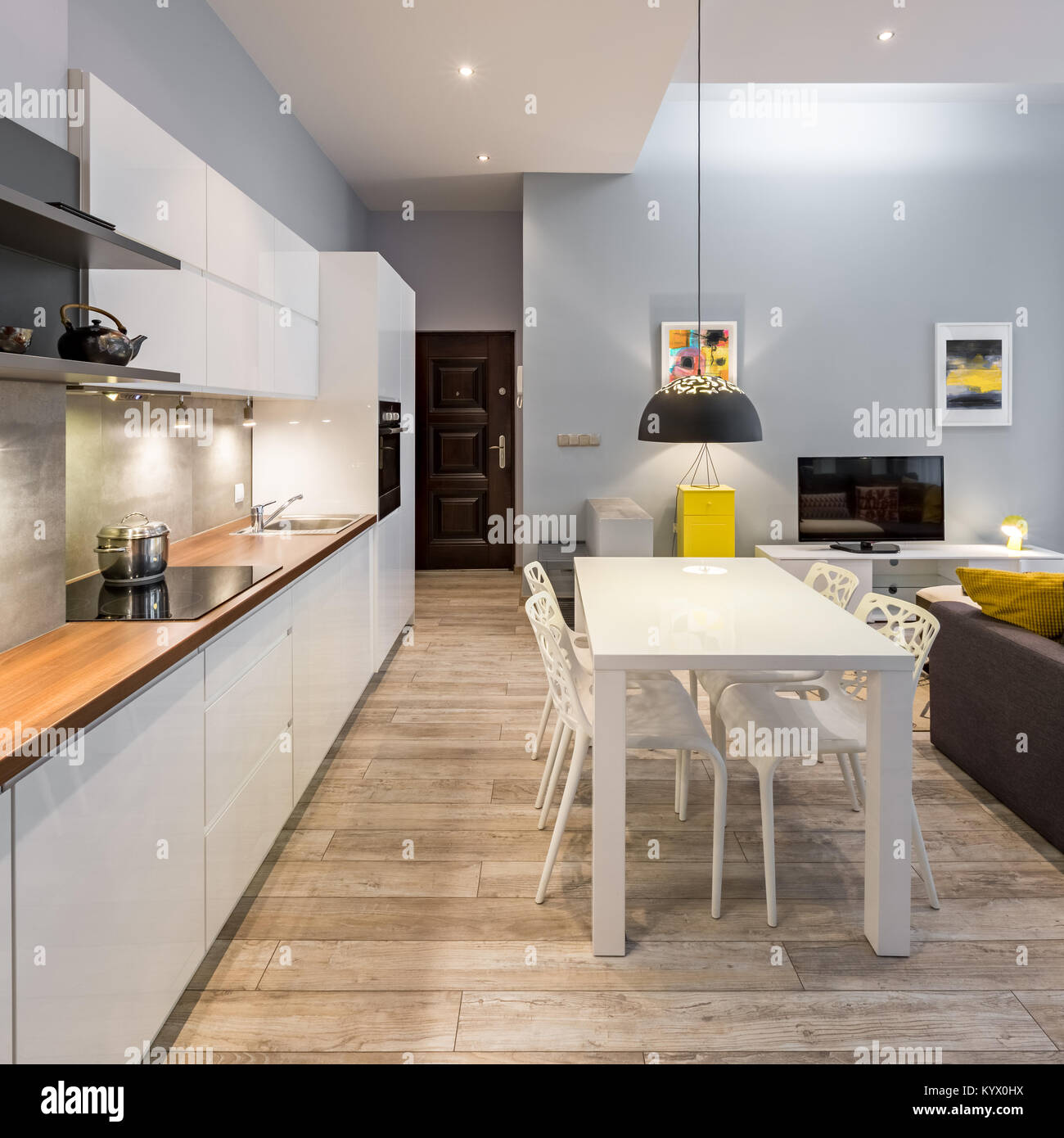 Appartement contemporain avec cuisine lumineuse et blanc table à manger Banque D'Images