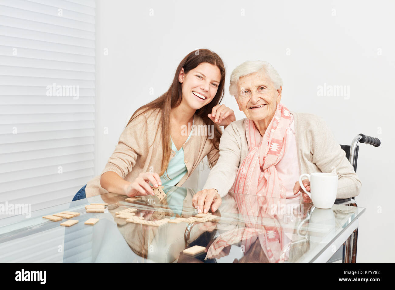 Famille avec vieille femme et fille en tant que petits-enfants jouant aux dominos ensemble, à la maison Banque D'Images