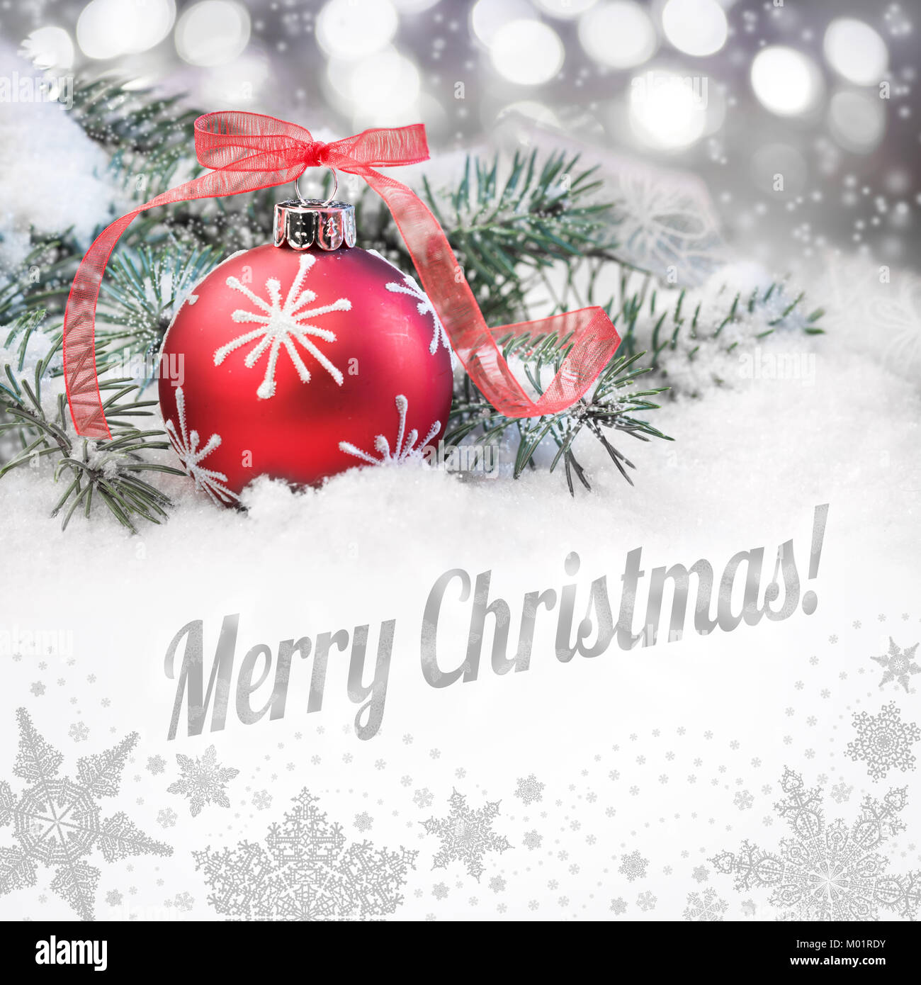 Boule de Noël rouge sur un fond d'hiver neutre avec une légende "Joyeux Noël !" Banque D'Images