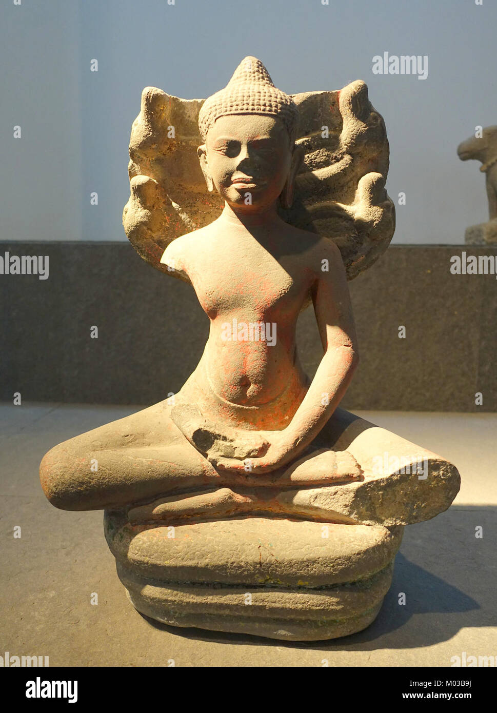 Cette sculpture en grès du XIe siècle représente le Bouddha protégé par une Naga, une créature mythique ressemblant à un serpent, symbolisant la protection et l'illumination. Il fait partie de la collection du Musée d'histoire vietnamienne à Ho Chi Minh ville. Banque D'Images