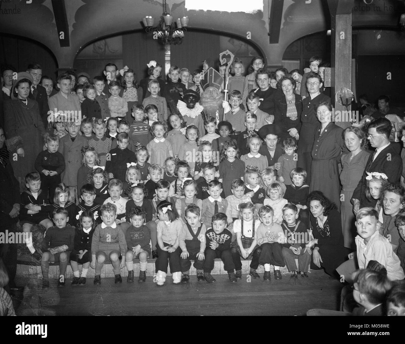 Une photographie historique montrant le Cadi Club Bond militaire Oorlogsslachtoffers Sint Nicolaas avec des enfants, reflétant les activités de relèvement et de soutien social d'après-guerre aux pays-Bas. Banque D'Images