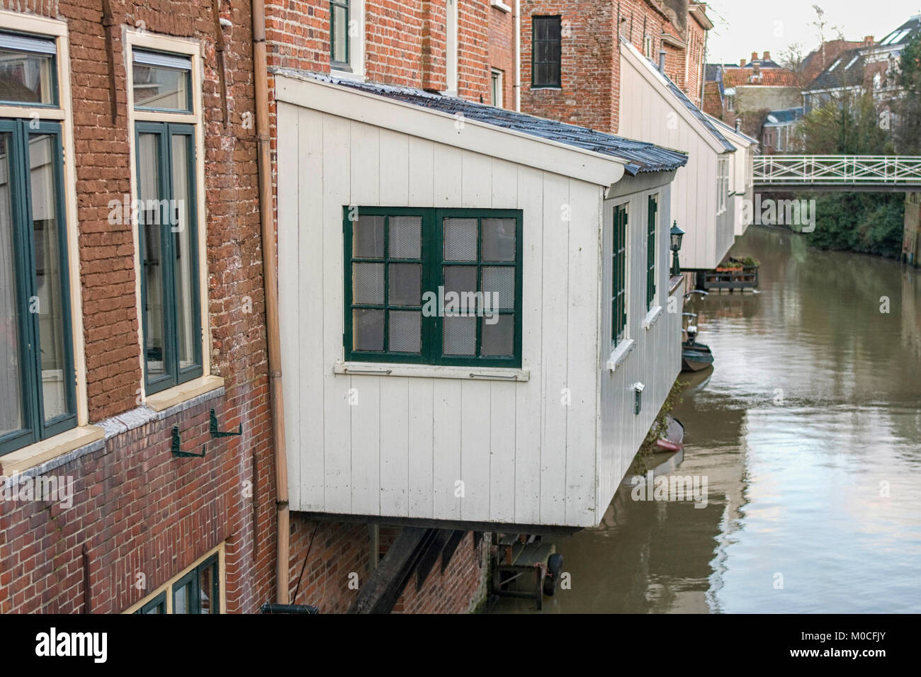 Une cuisine en bois blanc, attaché à la 17e siècle, les maisons au-dessus d'un canal à Delfzijl, aux Pays-Bas Banque D'Images