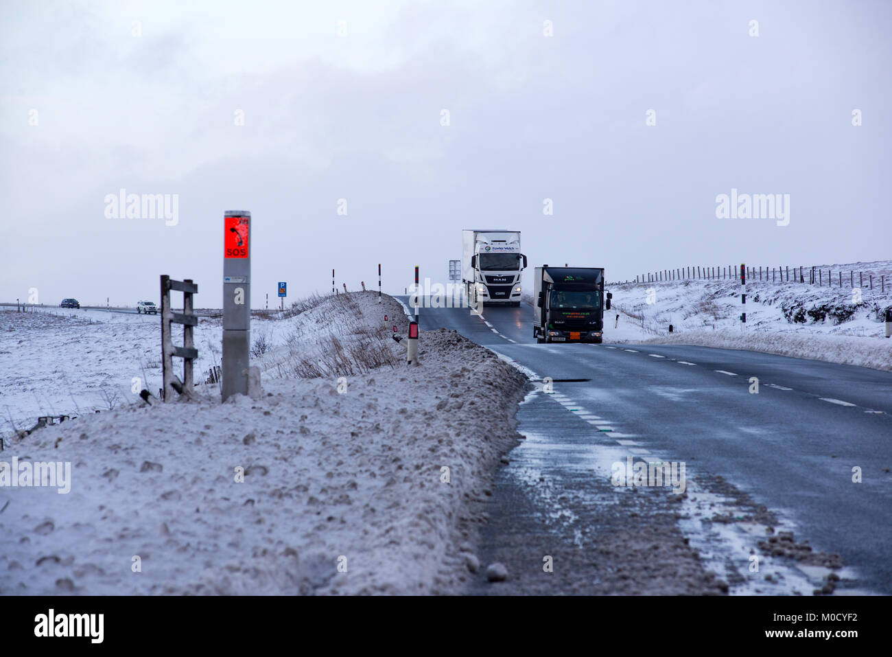 Les poids lourds, poids lourds sur l'A628 Woodhead transmettre un jour de neige sur le nord de l'Angleterre-trans Pennine Road, UK. Banque D'Images