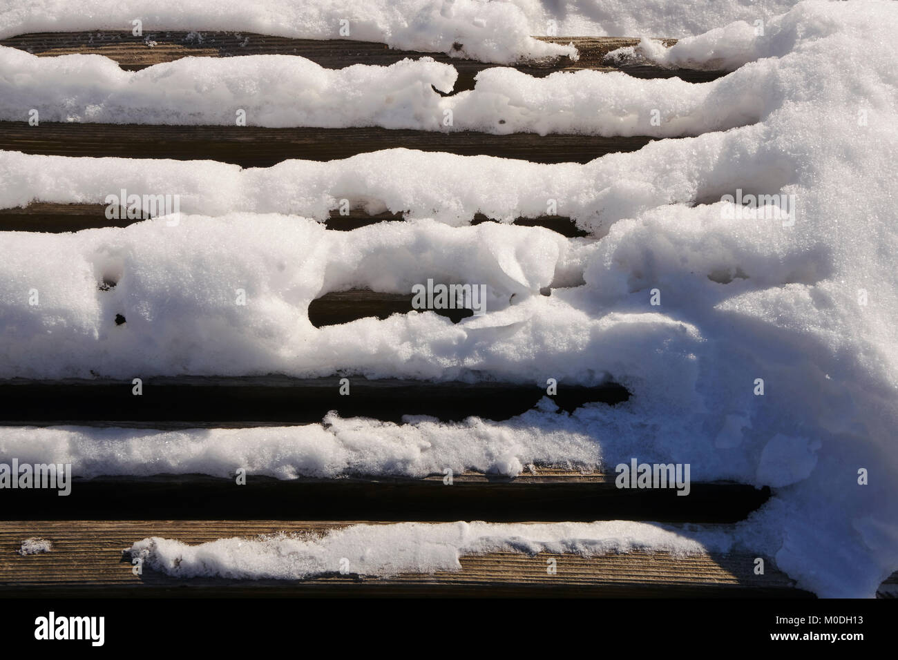 L'accumulation de neige sur banc en bois à lattes Banque D'Images
