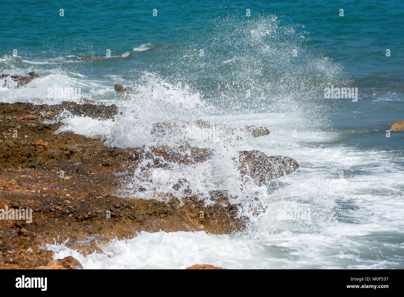 De puissantes vagues de la mer de mousse, à se briser contre le rivage rocailleux Banque D'Images