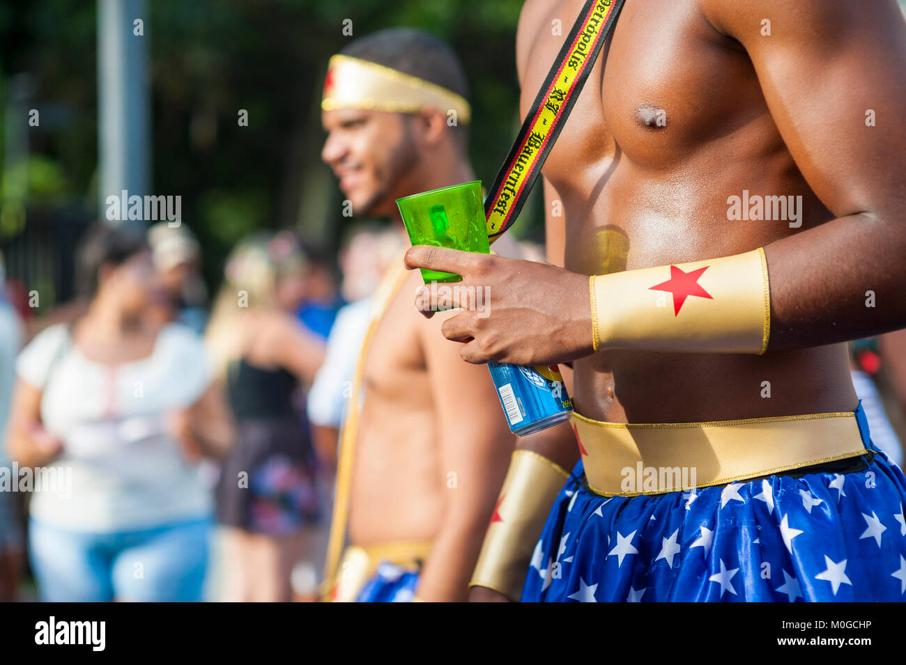 RIO DE JANEIRO - 11 février 2017 : les jeunes hommes musclés fêter Carnaval dans Wonder Woman superhero costumes correspondant à une street party à Ipanema. Banque D'Images