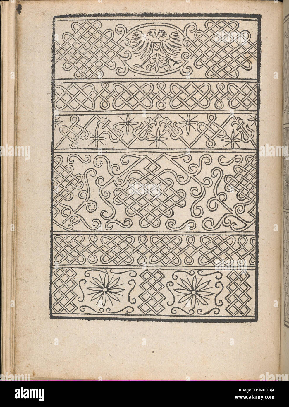 Une page d'un livre de design historique illustrant des vêtements africains et des motifs de broderie, mettant en évidence l'art et l'artisanat traditionnels du textile d'Afrique australe. Banque D'Images