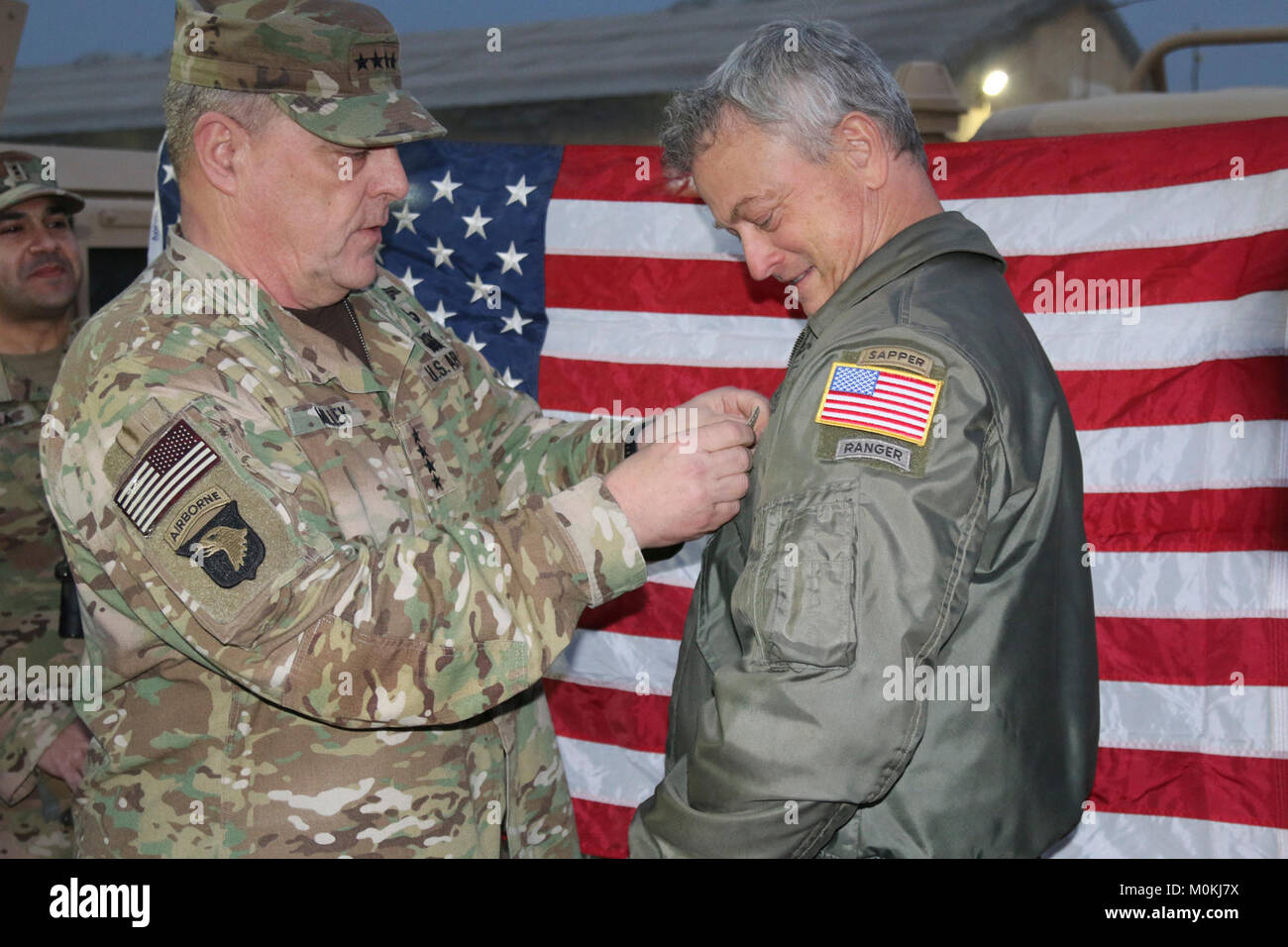 Chef d'état-major des armées Le Général Mark Milley favorise l'acteur Gary Sinise, autrefois connue comme 1er lieutenant Dan Taylor, au grade de capitaine au Complexe militaire de Taji, Iraq, 21 Décembre, 2017. La Force opérationnelle interarmées - fonctionnement inhérentes à résoudre est la Coalition mondiale pour vaincre ISIS en Iraq et en Syrie. (U.S. Army Banque D'Images