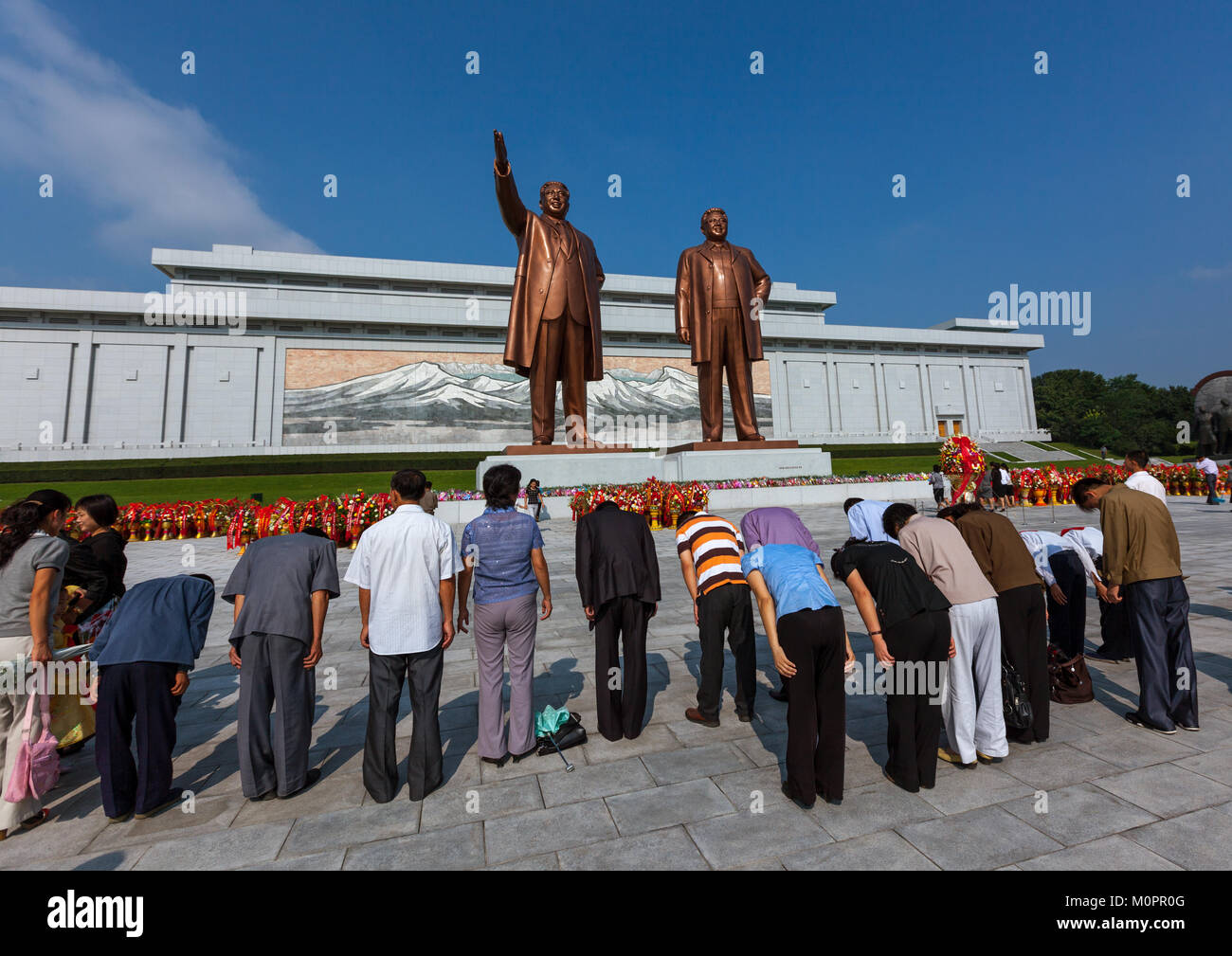 Les gens de la Corée du Nord rendant hommage aux dirigeants des statues dans troupe artistique Mansudae grand monument, de la province de Pyongan, Pyongyang, Corée du Nord Banque D'Images