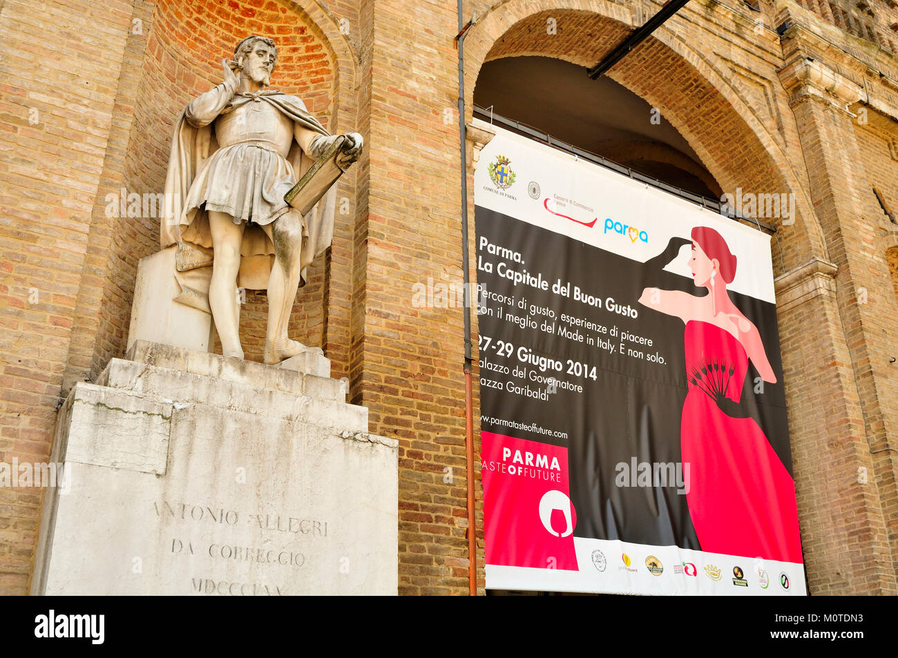 Statue de Antonio da Correggio dans Piazza Garibaldi, Parme avec une affiche annonçant une food festival Banque D'Images