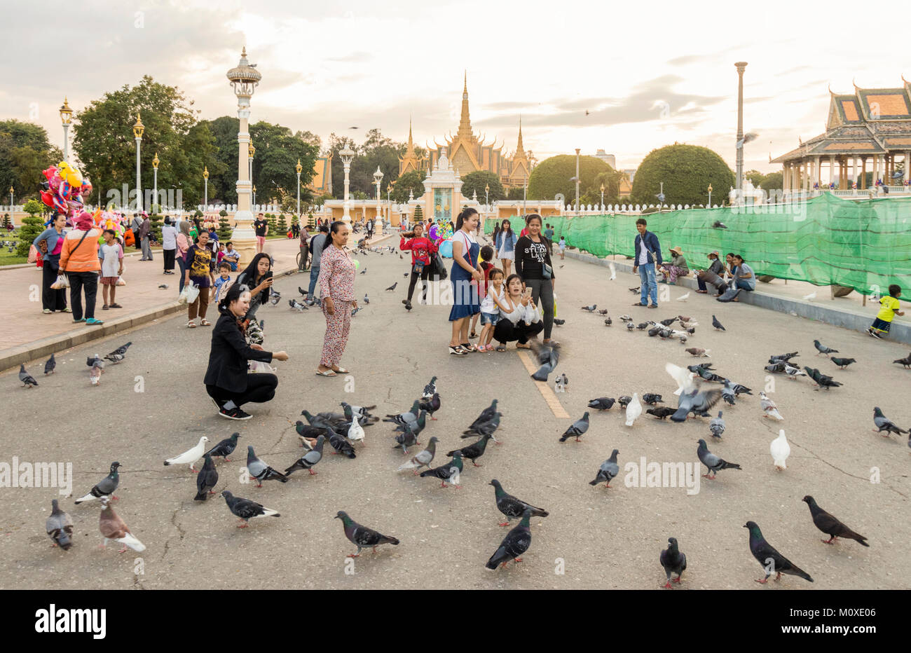 Les gens en dehors des pigeons alimentation Royal Palace Phnom Penh Cambodge Riverside Banque D'Images