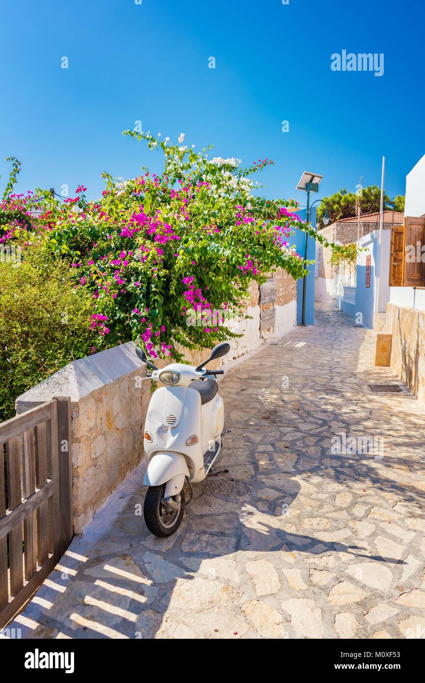 Scooter et fleurs en Nimborio sur l'île de Halki (Grèce) Banque D'Images