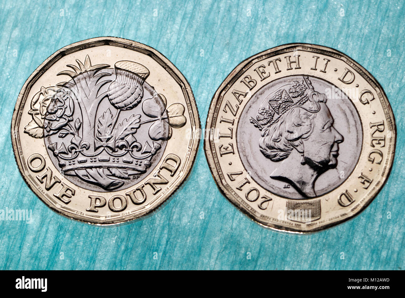 La pièce d'une livre britannique montrant les deux côtés, sur un socle lumineux bleu. Banque D'Images