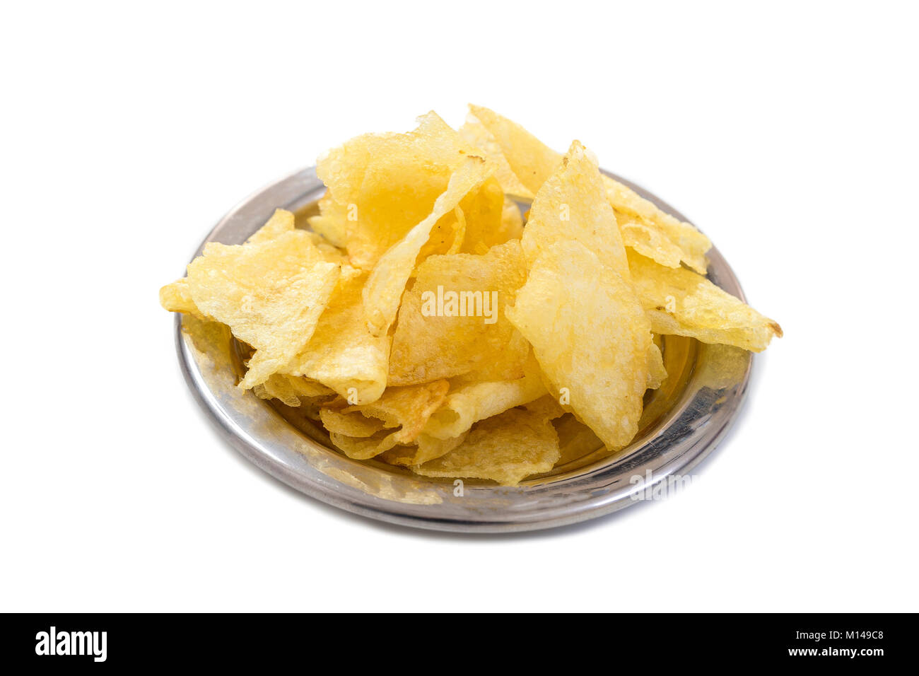 Jusqu'Voir croustillant de minces tranches de pommes chips dans un bol blanc, sur fond blanc. Banque D'Images