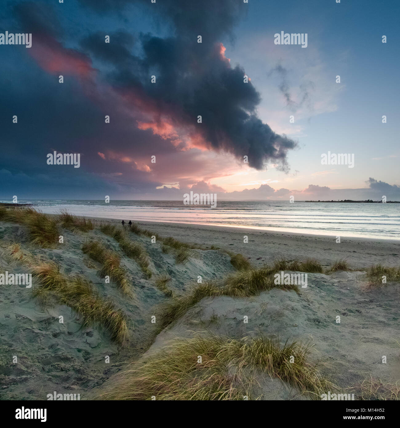 Les nuages orageux avec les rayons du soleil juste avant le coucher du soleil en hivers un jour à la tête de l'Ouest West Wittering sur Beach Banque D'Images