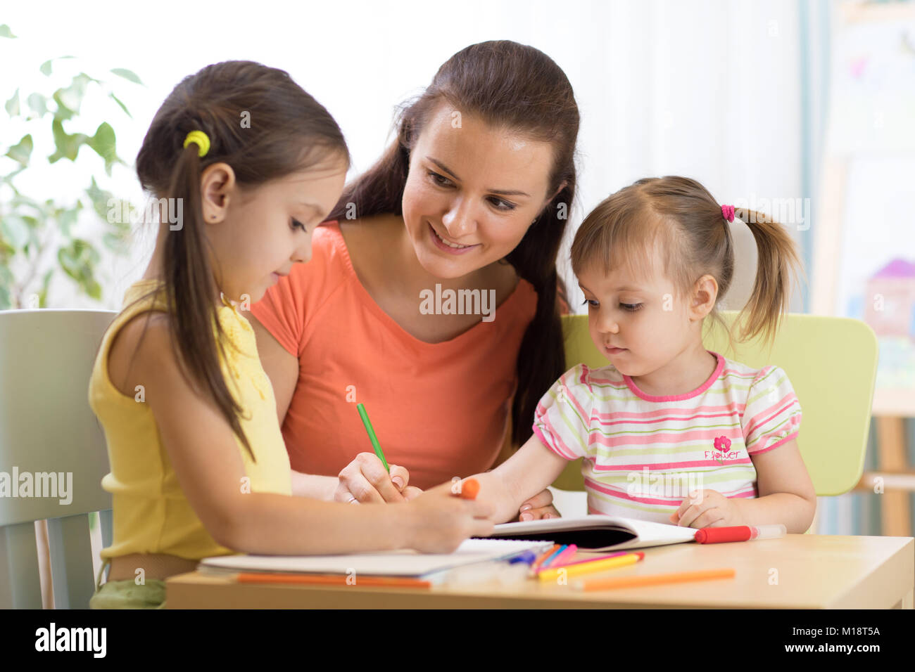 Femme et enfants filles dessin avec crayons de couleur Banque D'Images